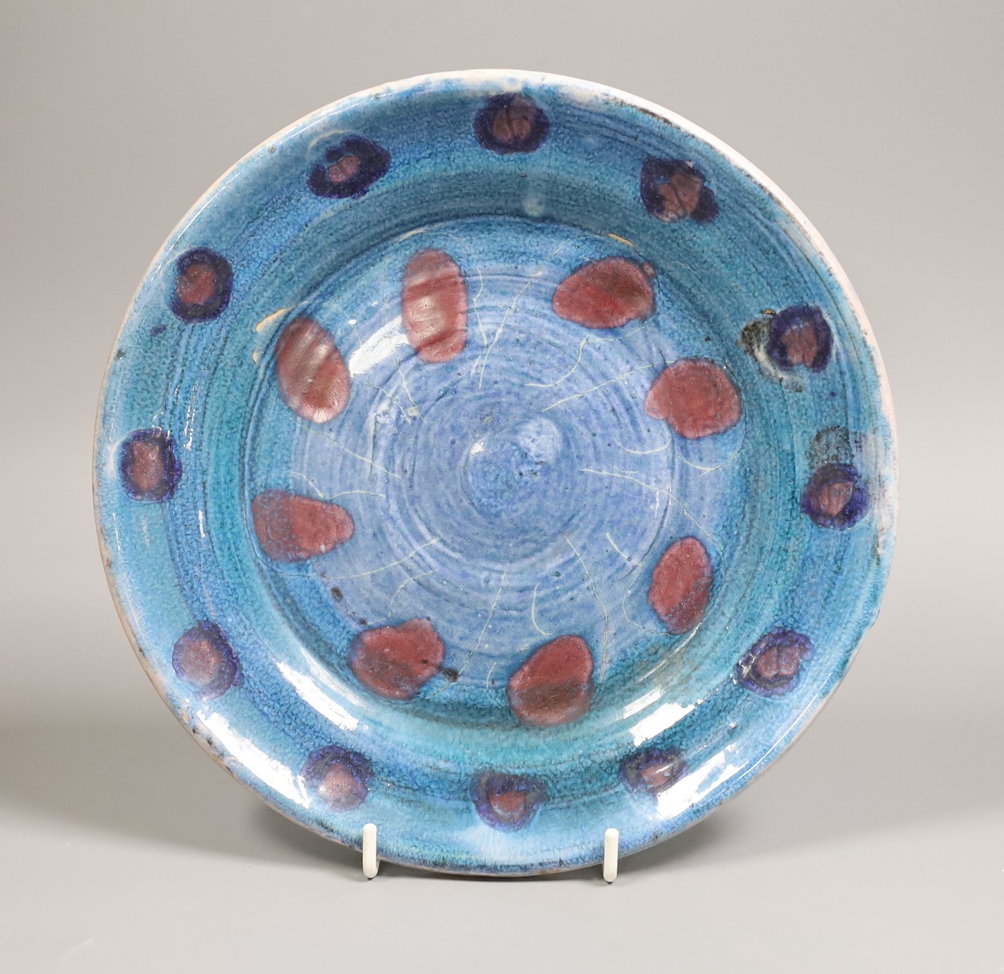 Quentin Bell, Fulham pottery blue glazed wall plate, 23 cms diameter